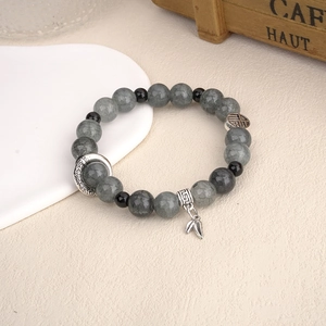 Handmade stone beaded bracelet with vintage silver charms and Fu tag in retro style