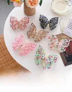 Detailed close-up of butterfly hair clips in various floral and amber prints