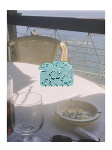 Detailed view of mint green acetate hair claw with Fu character and cutout design
