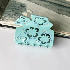 Elegant mint blue acetate flower hair claw clip with hollow floral pattern and rhinestones