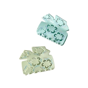 Floral acetate hair claws in light blue and green with rhinestones and hollow design