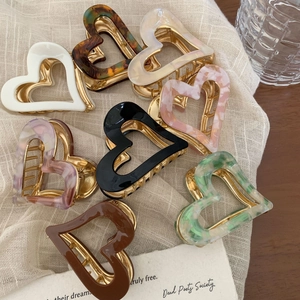 Elegant acetate heart-shaped hair claw clips in various colors for women's hairstyles