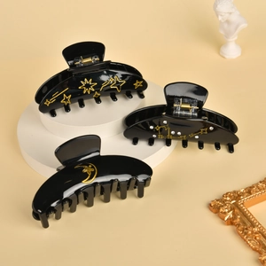 Elegant vintage black acetate hair claws with gold star and moon patterns for women
