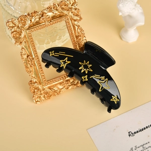 Elegant black acetate hair claw clip with gold star moon pattern for women