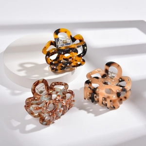 Three-piece floral acetate hair claws with hollow flower design and crystal rhinestones