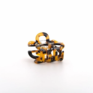 Close-up of tortoise shell pattern acetate hair claw clip with sparkling crystal rhinestone