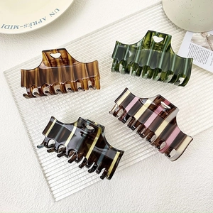 Set of four checkered acetate hair claws with hollow heart design in various retro colors