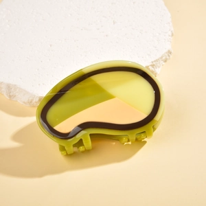 Detailed view of the avocado-shaped acetate hair claw with tricolor block design