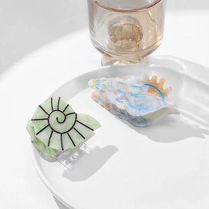 Modern acetate hair claw clips in ocean seashell shapes for elegant hairstyling
