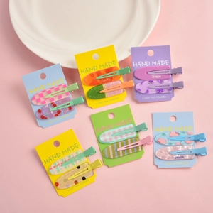 Set of fruit themed matte hair clips featuring peach and grape patterns on cards