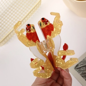 Acetate lion hair claw clip with amber marble texture and red mane for thick hair styling