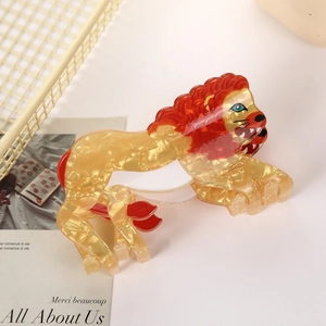Detail of cute lion hair claw clip made of golden acetate resin with red mane