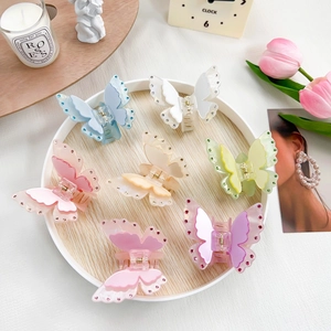 Elegant 7-piece set of butterfly hair claws with rhinestones in various pastel colors
