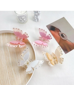 Detailed macro of the double-layered butterfly hair claw with rhinestone accents