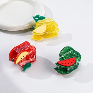 Detail view of lemon, apple, and watermelon acetate fruit hair claws with textured finish