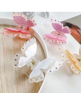 Close-up of elegant double-layered butterfly hair clips with sparkling rhinestone edges