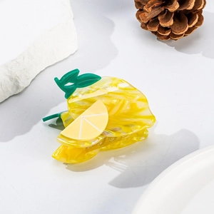 Detail of lemon shaped acetic acid hair claw clip with yellow semi-transparent finish