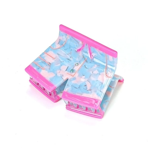 Pink and blue denim shorts shaped acetate hair claw clip with marble texture on white background