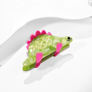 Pince à cheveux dinosaure verte en acétate avec détails roses et texture marbrée
