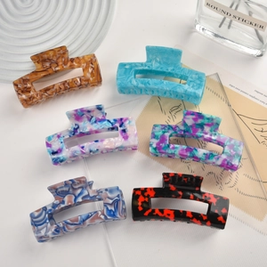 Macro shot of large rectangular acetate claw clips in assorted marble and tortoise patterns