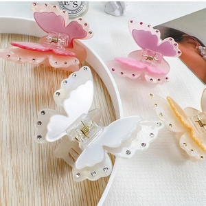 Elegant butterfly claw clips with sparkling rhinestones and translucent finish in multiple colors