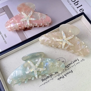 Elegant large starfish hair claws in pink, beige, and green with a pearlescent finish