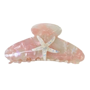 Pink marble acetate hair claw clip featuring large pearl starfish and glitter starfish