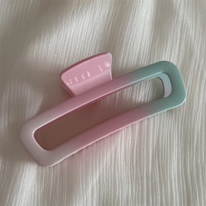 Detail of rectangular claw clip with pink and light blue gradient hollow design