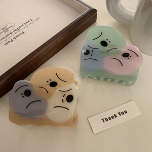 Minimalist acetate hair claw clips with cartoon faces in colorful color blocking designs