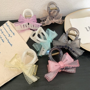 Set of transparent bow hair claws in pastel colors with glossy finish and metal spring