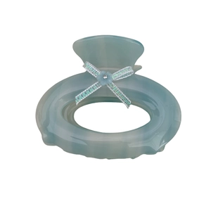 Light blue acetate oval hair claw clip with a sequined bow and crystal floral detail