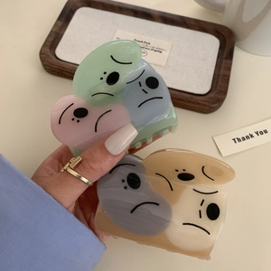 Medium acetate hair claw clips with minimalist face patterns in soft pastel colors