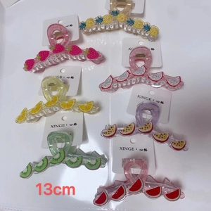 Set of 7 colorful fruit resin hair claws showing various styles and 13cm size detail