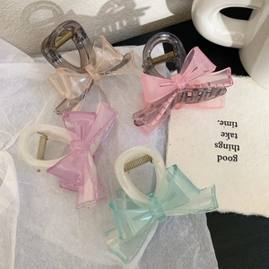 Set of four sweet transparent bow hair claws in champagne, pink, purple, and teal colors