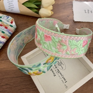 Lot de serre-têtes brodés à fleurs style ethnique rose et jaune sur fond bois rétro