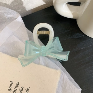 Detailed view of medium hair claw clip with light blue mesh bow and gold metal spring