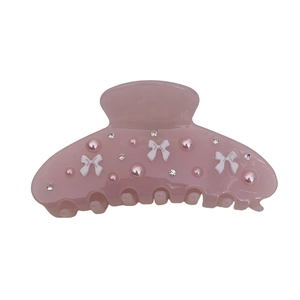 Pink acetate flower hair claw clip with white bows, pearls, and rhinestones
