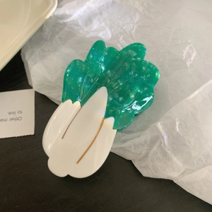 Detailed view of creative cabbage-shaped hair claw made of premium marbled acetate