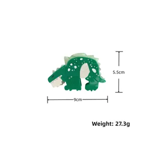Detail view of a 9cm green dinosaur hair claw clip with crystal accents and sizing specs