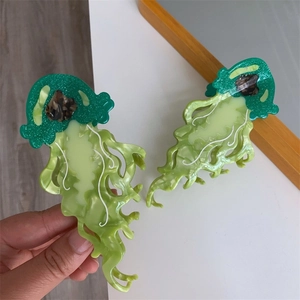Vibrant jellyfish-shaped large acetate hair claw clip with emerald green marble finish
