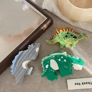 Three-piece acetate dinosaur hair claw clips set including stegosaurus and long neck designs