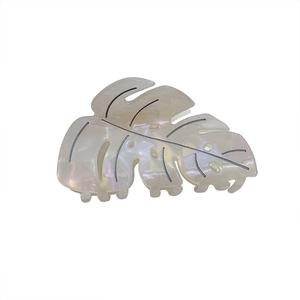 Elegant monstera leaf hair claw clip with pearlescent white finish and black vein details