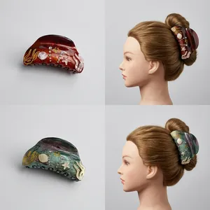 Marine theme hair claw clip with starfish shells and rhinestones in green and amber