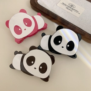 Three panda-shaped acetate hair claws in pink, iridescent black, and brown for women
