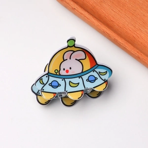 Detail of a colorful UFO and rabbit acrylic hair claw clip with smooth polished edges