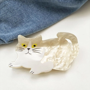 Detailed macro view of the cute cat shaped acetate hair claw clip with pearl cream finish