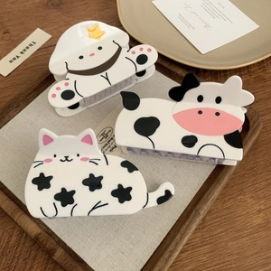 Cute set of three animal hair claws featuring cat, cow, and dog designs in white and black