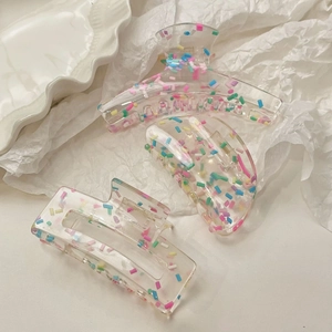Colorful transparent candy dots hair claw clips set in various shapes on white background