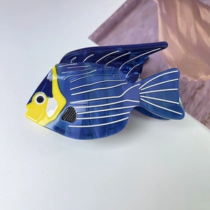 Detailed macro view of acetate blue tropical fish hair claw with marble texture finish