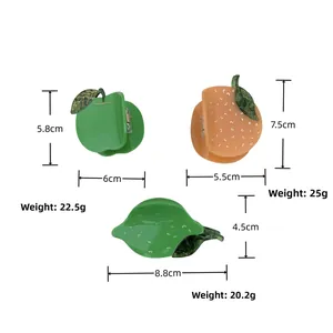 Detailed view of acetate hair claws in apple, orange and lemon shapes with size data